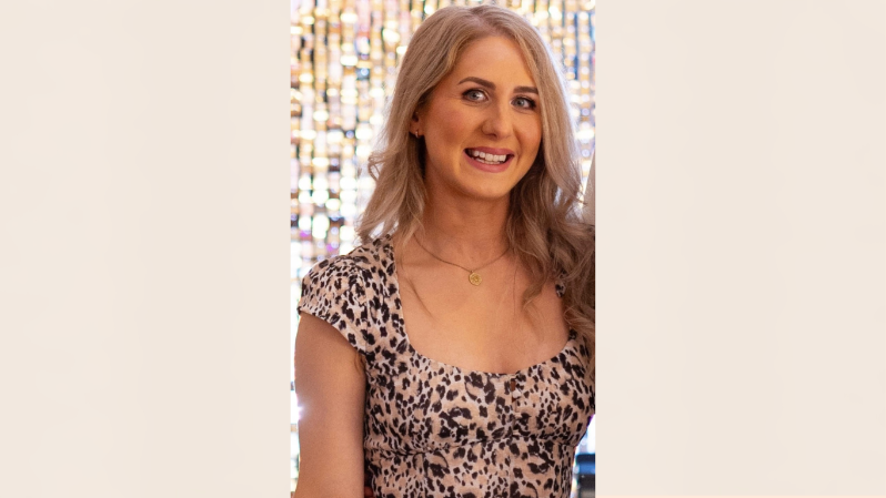 Smiling woman with blonde hair in a leopard print top